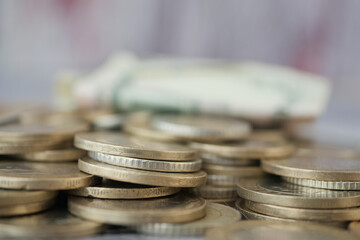 Coins and banknotes arranged on a surface during daylight