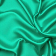 Obraz premium Blue green silk satin. Soft, wavy folds. Shiny fabric surface. Luxurious emerald green background with copy space for design. Web banner. Birthday, Christmas, Xmas, Valentine, holiday, concept.