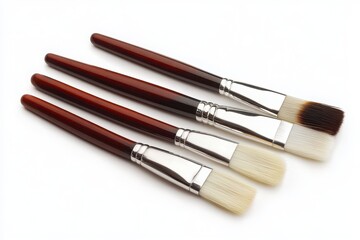 Fototapeta premium three paintbrushes arranged neatly white