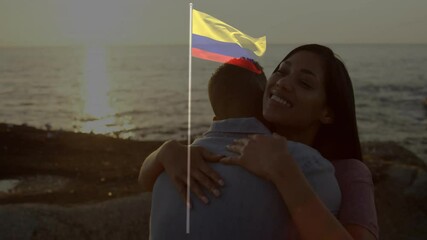 Couple embracing by ocean with Colombian flag animation over sunset background - Powered by Adobe