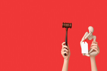Woman holding auction gavel and antique statuette on red background
