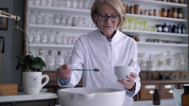 Pharmacist preparing compound in mortar and pestle
