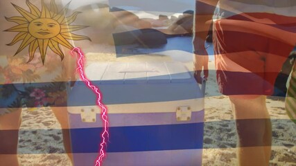 Uruguay flag animation over people carrying cooler on sunny beach - Powered by Adobe