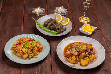Menorah lighted candles in candlesticks with the Star of David at the set table