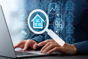 Researching real estate price trends and mortgage interest rates. Man using laptop computer to buy home.