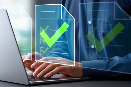 Document approval process and completion. Approval workflow and legal document compliance. Businessman using laptop computer to approve documents.