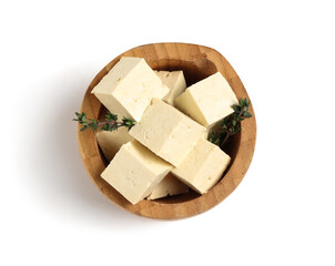 Wooden bowl with cut tofu cheese isolated on white background