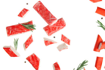 Cut tasty crab sticks with peppercorns and rosemary flying on white background © Pixel-Shot