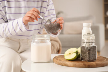 Young woman making chia seed yogurt at home, closeup