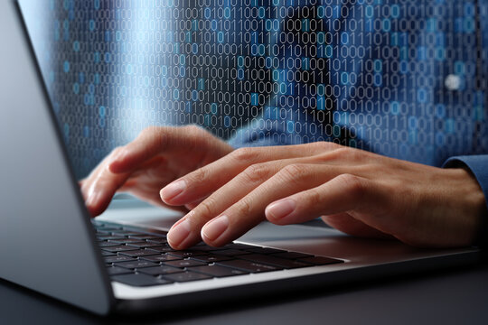 Binary data processing and data encoding. Digital data processing technology. Engineer using laptop computer to analyze binary data.