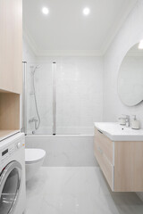 Toilet bowl, sink and bathtub in the bathroom