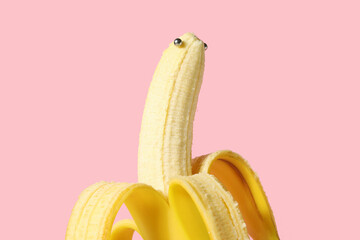 Banana with piercing on pink background