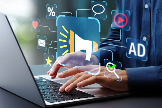 Digital marketing strategy. Announce promotions and campaigns via email and social media. Marketer using laptop computer to manage targeted advertising.