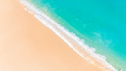 Stunning summer seascape with gentle waves rolling onto an untouched white sand beach.