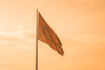 Turkish flag against a background of sunset sky