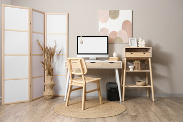 Interior of office with photographer's workplace and folding screen