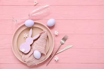 Stylish table setting with Easter eggs, bunny and beautiful flowers on pink wooden background