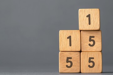 Close-Up of Stacked Wooden Blocks Displaying Numbers One and Five on a Gray Background