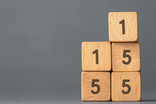 Close-Up of Stacked Wooden Blocks Displaying Numbers One and Five on a Gray Background