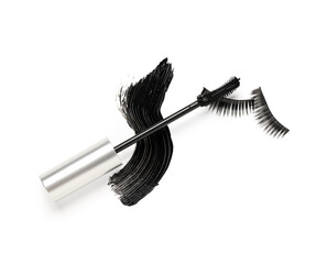 Black mascara brush in silver tube with sample and fake eyelashes on white background