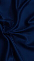 Black blue abstract background. Dark blue silk satin texture background. Beautiful wavy soft folds on the surface of the fabric. Navy blue elegant background with copy space for your design. Web banne