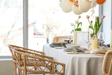 Elegant table setting with beautiful tulip flowers in restaurant