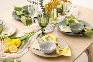 Table setting with spring flowers in room, closeup
