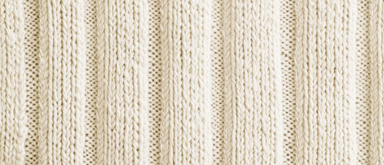 A textured, cream-colored knitted fabric featuring vertical stripes, ideal for cozy apparel or home decor.