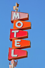 Motel Sign with Vertical Letters on Colored Geometrical Surfaces