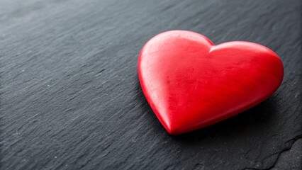 Fototapeta premium Red heart on dark background. Valentine's Day celebration concept. Copy space