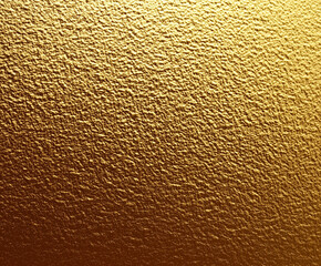 Fototapeta premium A gold colored wall with a texture that resembles wood grain