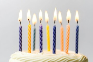 Colorful birthday cake with lit candles celebrating a joyful occasion, creating a festive atmosphere