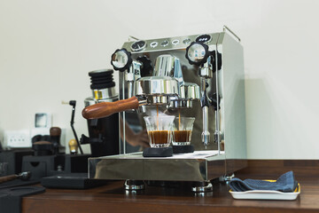 Espresso being drawn out of a espresso machine.