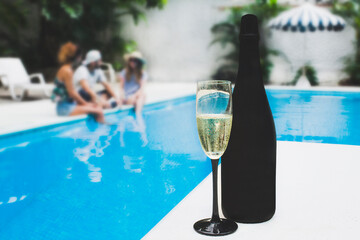 Celebrating with champagne by the pool: a luxurious summer getaway