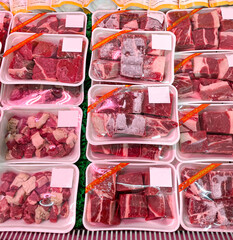 Pile of fresh red meat packed and displayed on supermarket