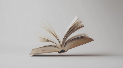 Fototapeta premium An Open Book With Pages Partially Floating In The Air