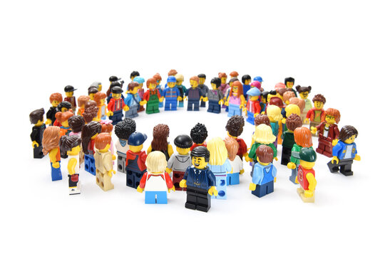 Many lego minifigures in group in circle shape isolated on white. Editorial illustrative image of popular children plastic constructor with studs.