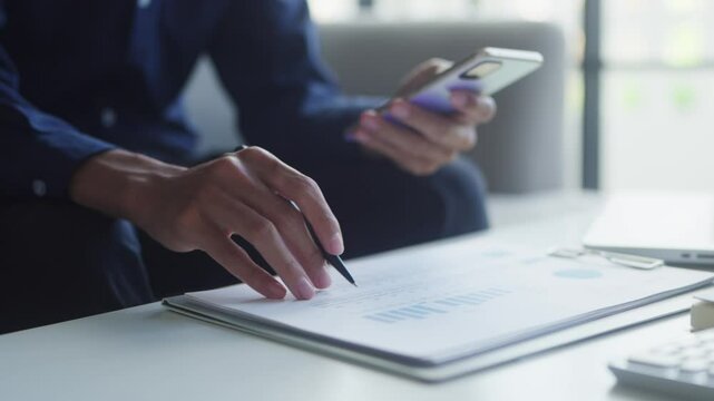 Man checking Financial on smartphone calculator pay bills taxes financial at home