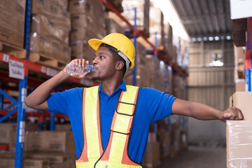 Warehouse worker, drinking water, African American male worker at warehouse. Warehouse male worker...