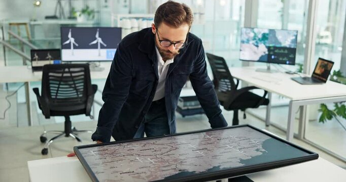 Corporate, man and interactive display for map in office of global selection, location and wind turbine project. Person, worldwide screen and sustainable planning, windmill production and site choice