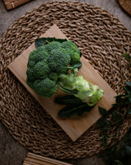 Organic Raw Fresh Green Broccoli on wooden board. Vegetables for diet and healthy eating.