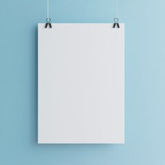 A simple image of a blank white paper or poster hanging on a light blue wall by two strings or clips.