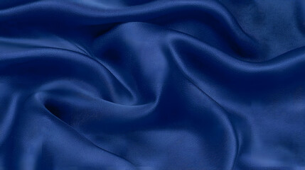 Fototapeta premium Royal Blue Silk: A luxurious close-up showcases the smooth, fluid texture of deep royal blue silk fabric, with soft folds and highlights that capture the light.