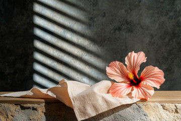 Beautiful Hibiscus Flower on Natural Stone Surface with Soft Fabric and Elegant Shadow Play