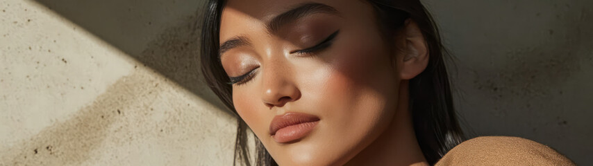 Fototapeta premium Woman with closed eyes enjoying sunlight in a serene indoor setting
