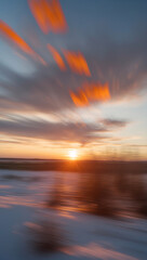 Naklejka premium Portrays a blurred sunset view, featuring vibrant orange clouds spreading across the evening sky