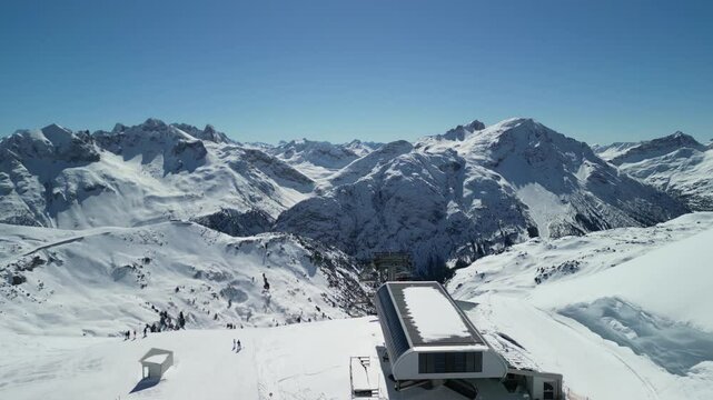 Epic drone footage of snow capped peaks in Austrian ski resort of Lech on a beautiful sunny clear blue day