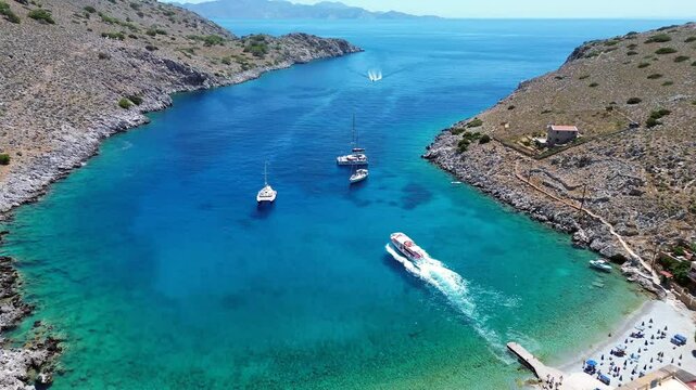 Aerial 4K Footage of Sunny Summer at Marathounda Bay: Boat Departs from Symi's Paradise