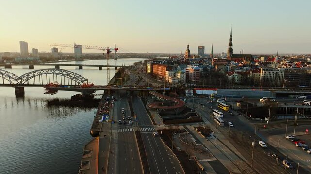 Iconic Riga cityscape shines at sunset with Rail Baltica bridge construction