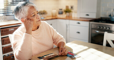 Thinking, senior woman and picture at house for mourning loss, memory past and reminder for...